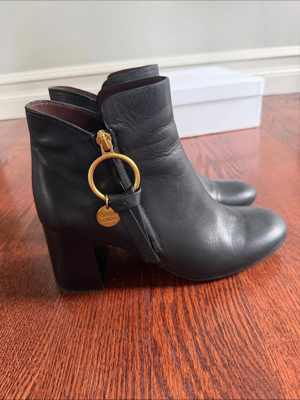 See By Chloé Black Leather Ankle Booties with Gold Ring Charm